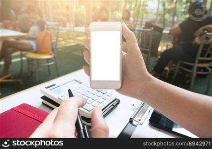 Businesswoman showing blank smart phone screen. girl using smart phone in cafe