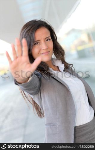 Businesswoman showing hand towards camera