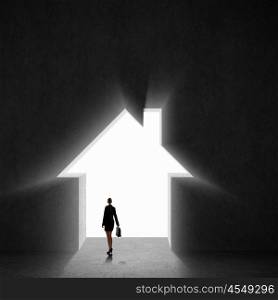 Businesswoman silhouette. Image of businesswoman silhouette standing with back against house