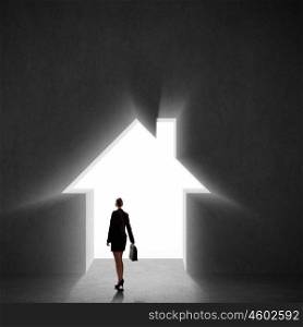 Businesswoman silhouette. Image of businesswoman silhouette standing with back against house