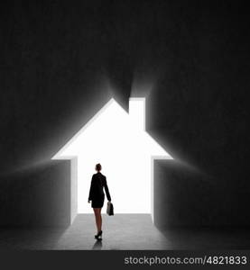 Businesswoman silhouette. Image of businesswoman silhouette standing with back against house