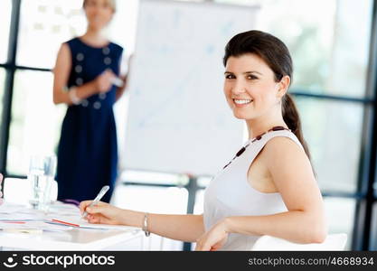 Businesswoman sitting and smiling at camera