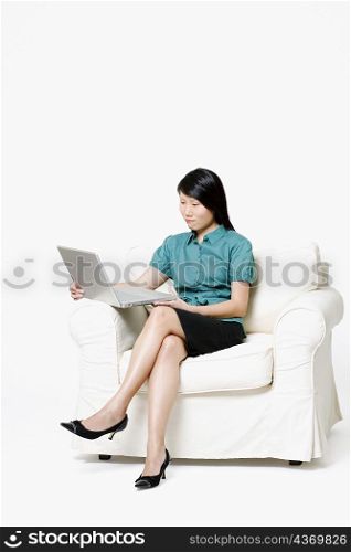Businesswoman sitting and using a laptop
