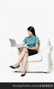 Businesswoman sitting and using a laptop