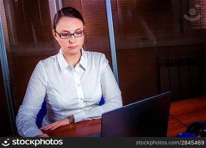 businesswoman sitting at a desk in an office