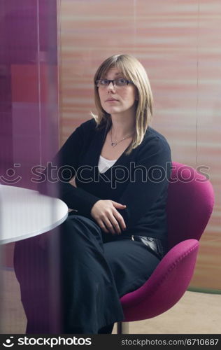 Businesswoman sitting at a table in an office