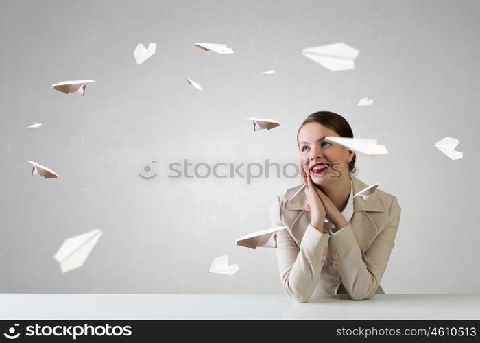 Businesswoman sitting at desk. Happy attractive businesswoman sitting at table in office