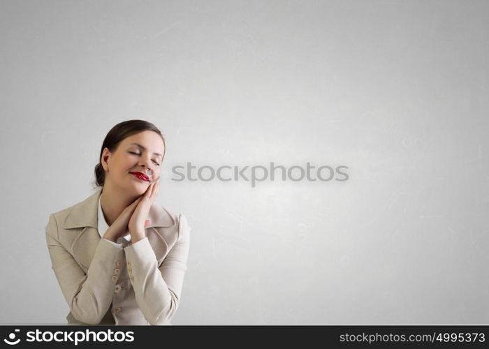 Businesswoman sitting at desk. Happy attractive businesswoman sitting at table in office