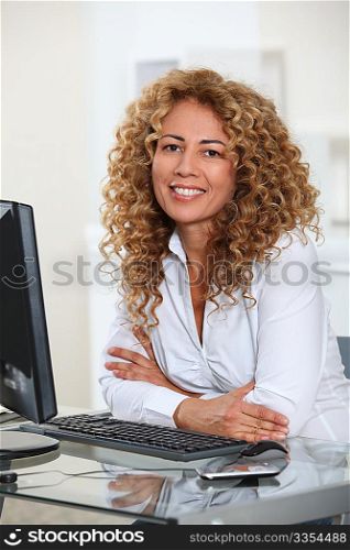 Businesswoman sitting at her desk in office