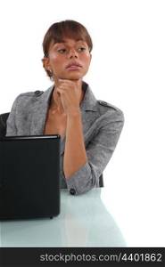 Businesswoman sitting at her desk with a laptop
