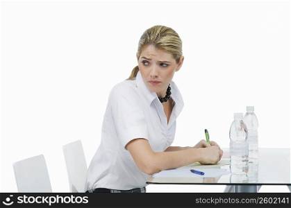 Businesswoman sitting in an office and looking sideways