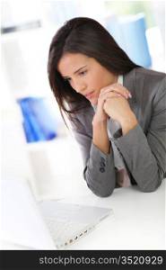 Businesswoman sitting in front of laptop computer