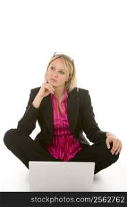 Businesswoman Sitting In Front Of Laptop Thinking