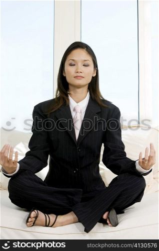 Businesswoman sitting in the lotus position