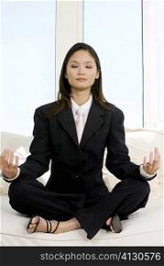 Businesswoman sitting in the lotus position