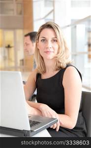 Businesswoman sitting in the office in front of laptop