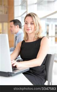 Businesswoman sitting in the office in front of laptop
