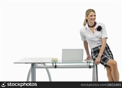 Businesswoman sitting on a table and smiling