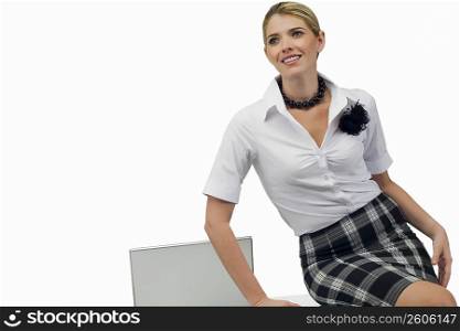 Businesswoman sitting on a table and smiling