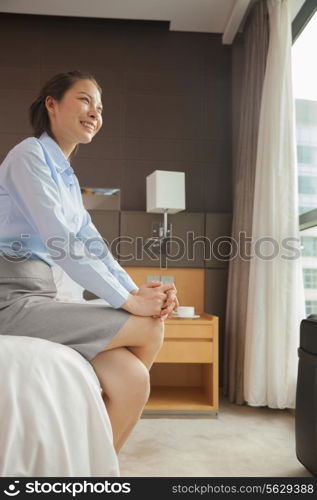 Businesswoman sitting on the edge of the bed