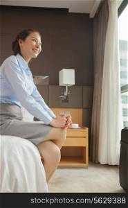 Businesswoman sitting on the edge of the bed