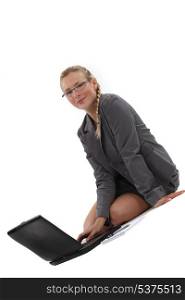 businesswoman sitting on the floor and working on her laptop