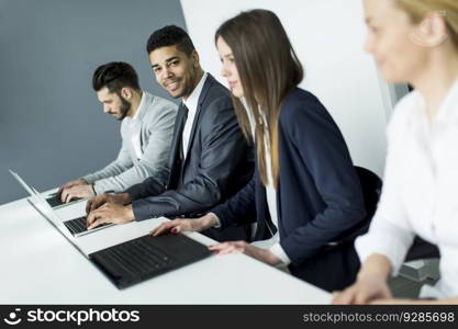Businesswoman sitting with her colleagues in the office
