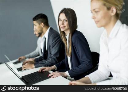 Businesswoman sitting with her colleagues in the office