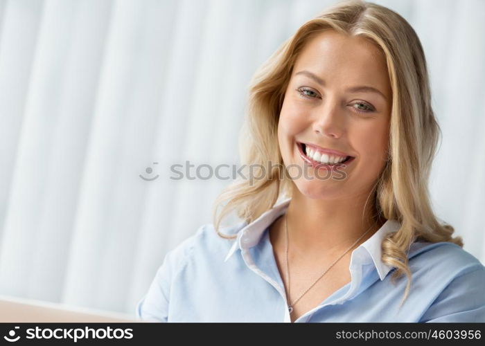 Businesswoman smiling and sitting in offfice