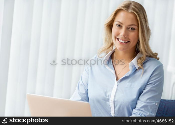 Businesswoman smiling and sitting in offfice