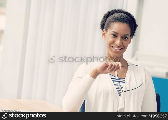 Businesswoman smiling and sitting in offfice