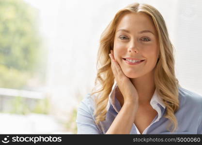 Businesswoman smiling and sitting in offfice