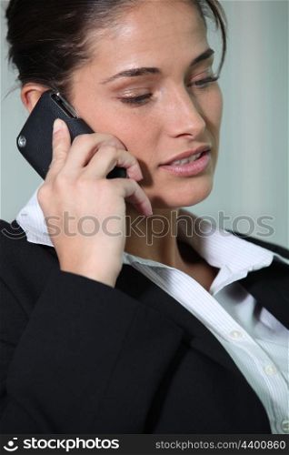 Businesswoman smiling holding mobile telephone