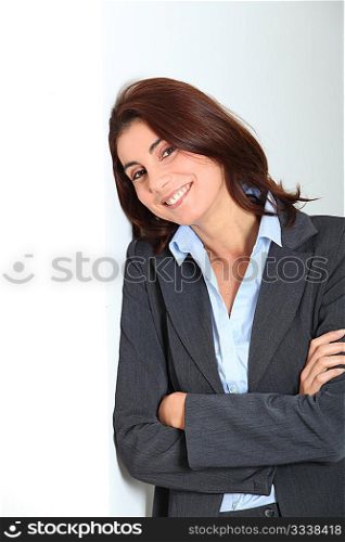 Businesswoman standing against white wall