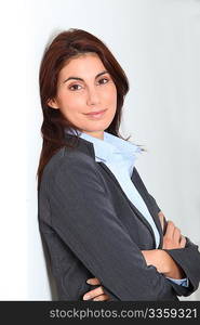 Businesswoman standing against white wall