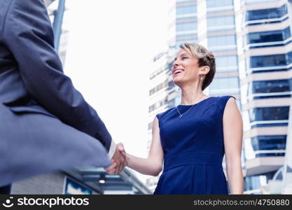 Businesswoman standing and talking to her colleague outdoors. Nice meeting out of the office