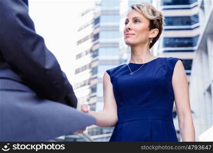 Businesswoman standing and talking to her colleague outdoors. Nice meeting out of the office