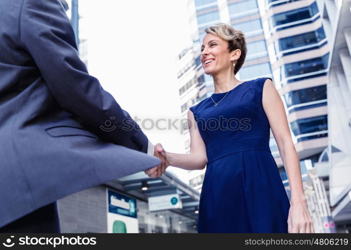 Businesswoman standing and talking to her colleague outdoors. Nice meeting out of the office