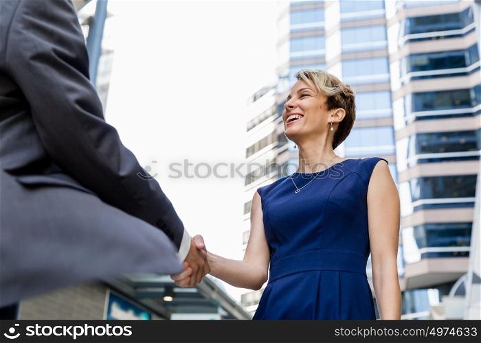 Businesswoman standing and talking to her colleague outdoors. Nice meeting out of the office