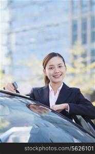 Businesswoman Standing by Car, Looking At Camera