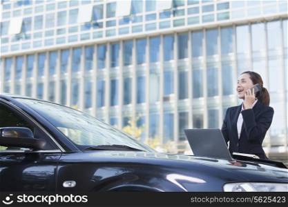 Businesswoman Standing by Car on the Phone