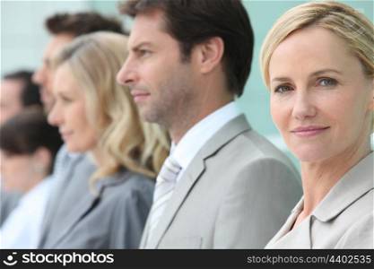 Businesswoman standing in a line