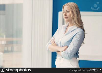 Businesswoman standing in front of window in offfice