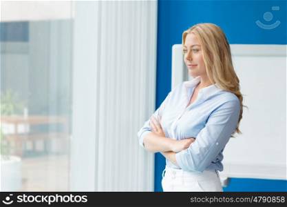 Businesswoman standing in front of window in offfice