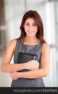 Businesswoman standing in hall with agenda