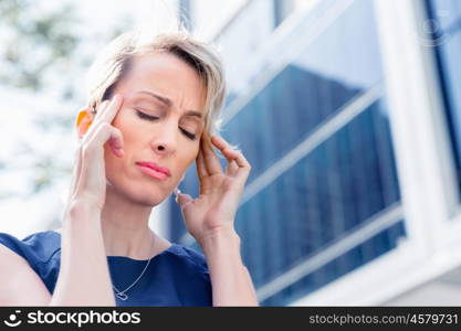 Businesswoman standing in street and trying to concentrate. I need to concentrate