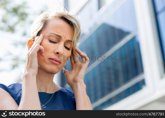 Businesswoman standing in street and trying to concentrate. I need to concentrate