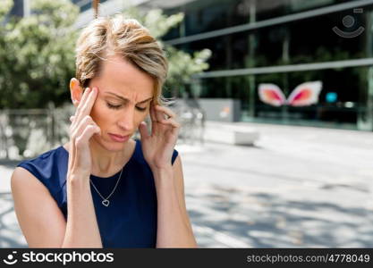 Businesswoman standing in street and trying to concentrate. I need to concentrate