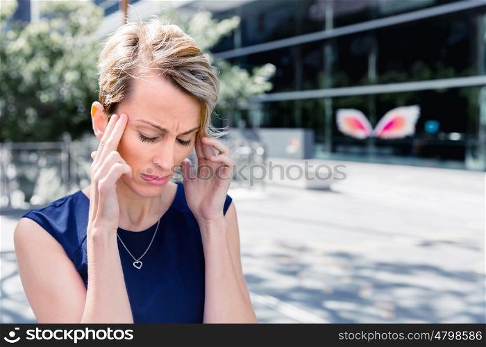 Businesswoman standing in street and trying to concentrate. I need to concentrate
