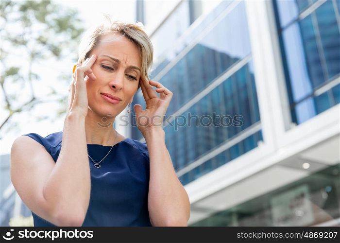 Businesswoman standing in street and trying to concentrate. I need to concentrate
